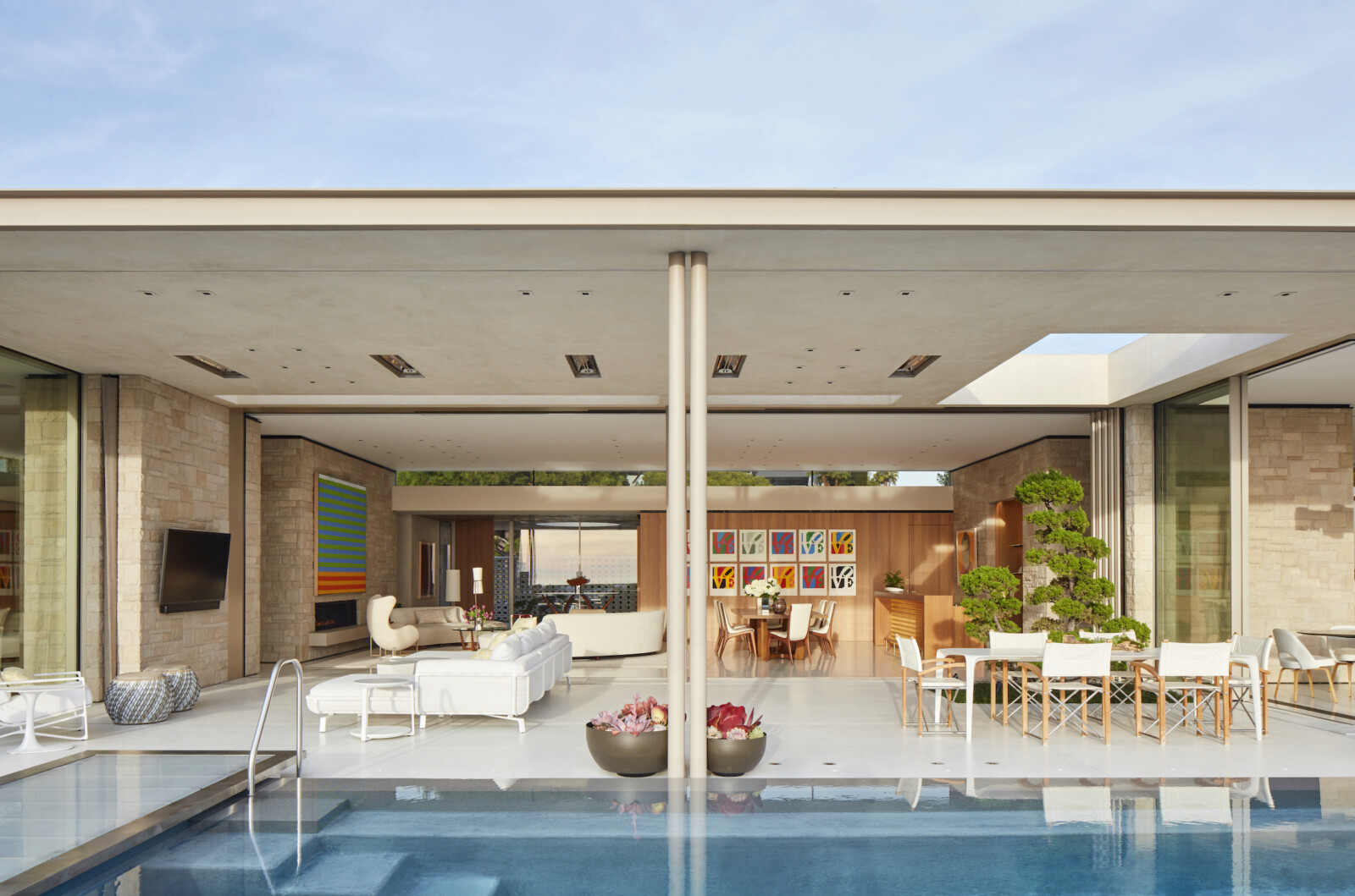 Main living room of home opens to pool and patio