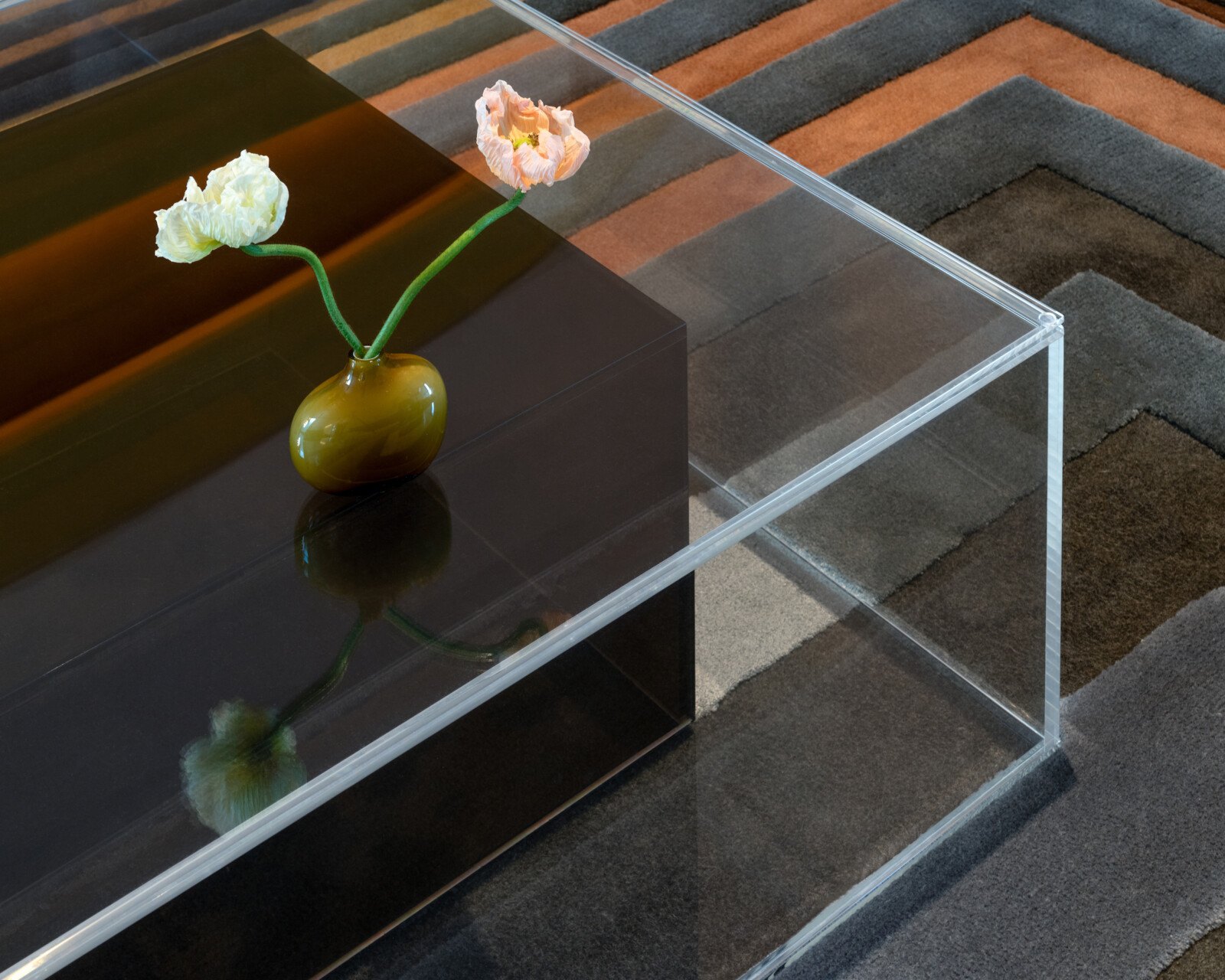 Echo Acrylic Coffee Table in living room focused on one corner