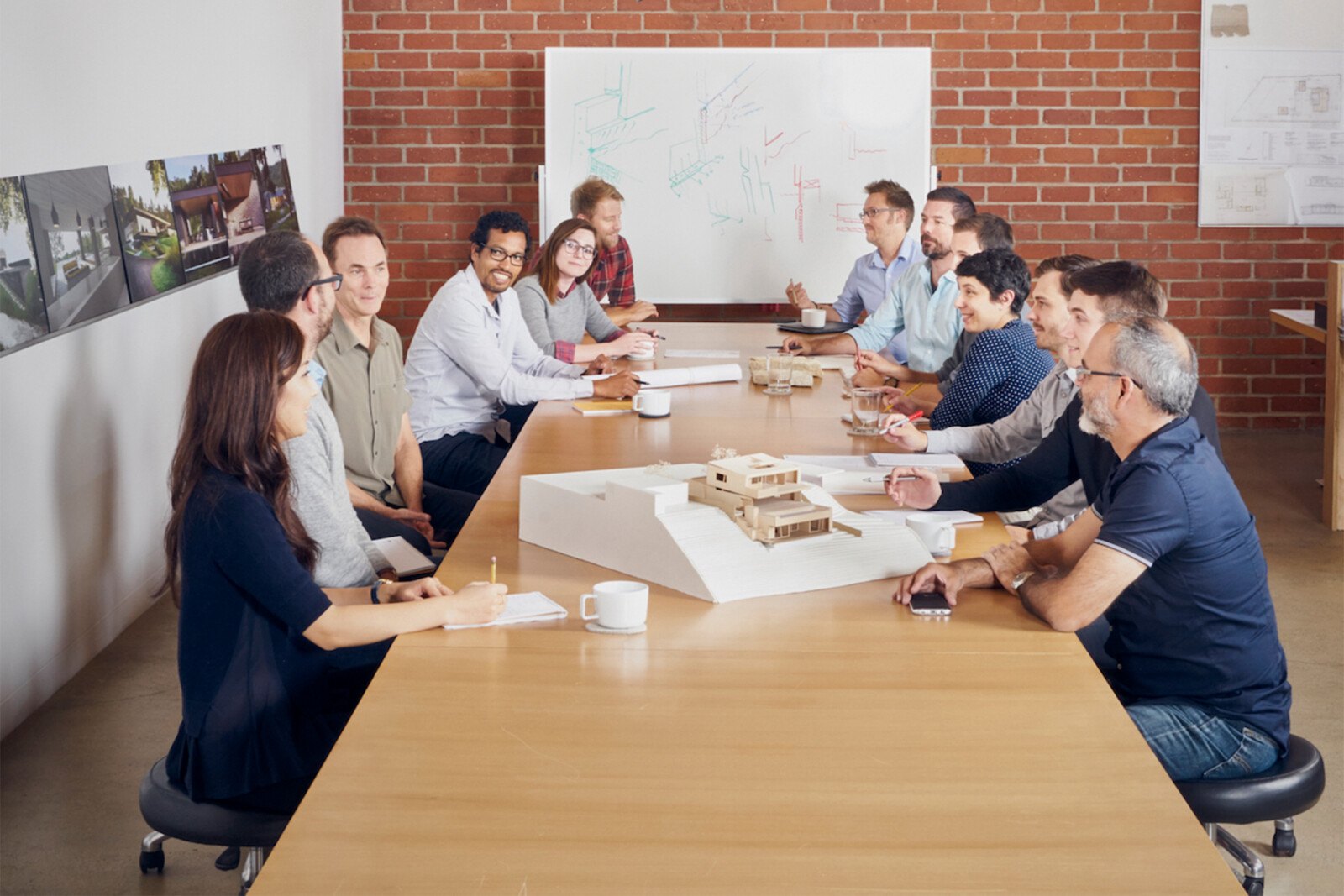 Employee Meeting Surrounding Physical Model of Project